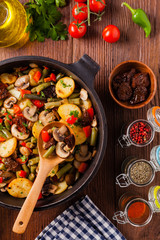 Fried pan vegetables, with mushrooms and dried tomatoes. Seasoned with a mix of herbs.