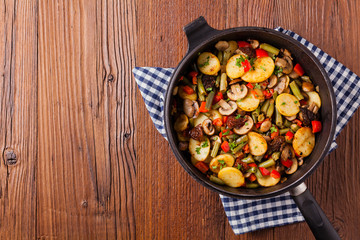 Fried pan vegetables, with mushrooms and dried tomatoes. Seasoned with a mix of herbs.