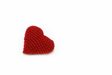 Red knitted heart isolated on white background. Valentine day symbol, concept of romantic love, blood donation, health care