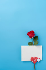 Greeting card concept of giving present at Valentine's, anniversary, mother's day and birthday surprise on blue background, copy space, top view