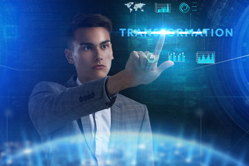 The concept of business, technology, the Internet and the network. A young entrepreneur working on a virtual screen of the future and sees the inscription: Transformation