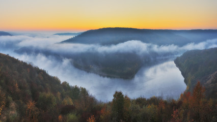 foggy canyon of a picturesque river. foggy autumn morning