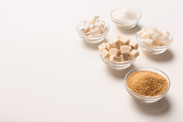 Various kinds of sugar cubes, pieces ands sand