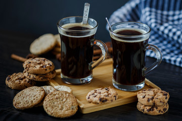 Two cups of coffee and chocolate and oatmeal cookies