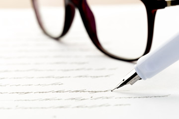 Fototapeta premium white fountain pen writing a letter, glasses