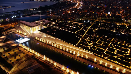 Fototapeta na wymiar Aerial drone night shot of iconic public settlement of illuminated Stavros Niarchos Foundation and cultural centre during Christmas time, Faliro, Attica, Greece