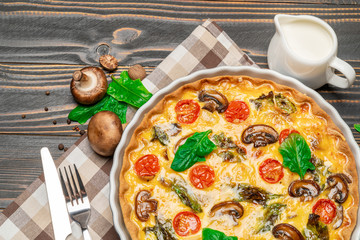 Baked homemade quiche pie in ceramic baking form