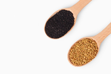 Wooden spoons with aromatic culinary condiments on white