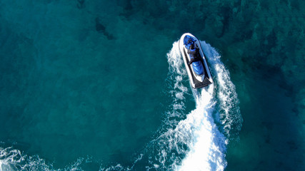 Aerial top view of jet-ski cruising in low speed in mediterranean emerald clear waters © aerial-drone