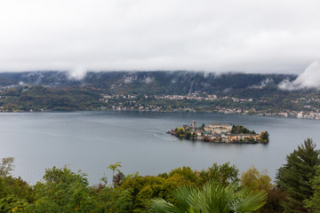 San Giulio Island. Orta in Italy. Mountains with fog