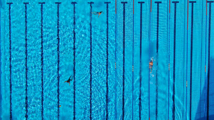 Aerial drone top view photo of people swimming in pool