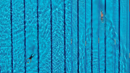 Aerial drone top view photo of people swimming in pool