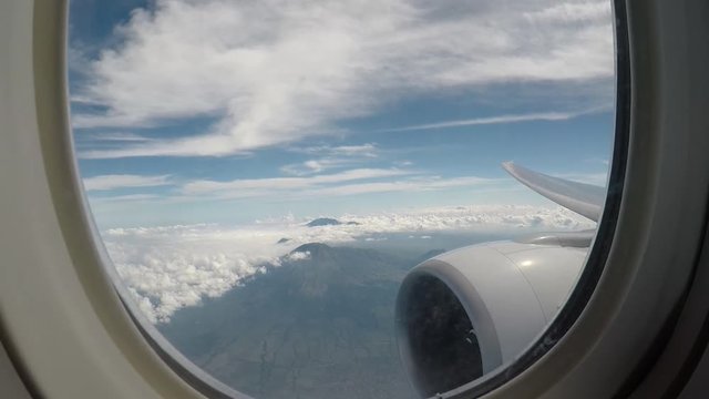 Volcanos view from aircraft window with aircraft engine and wing. Java Indonesia