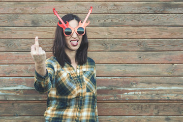 Portrait of young woman insulting with finger