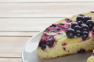 Homemade berry pie with black currants on light table. Shallow focus.