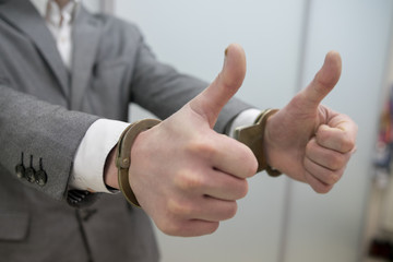 Closeup view of handcuffed man rising his hands.