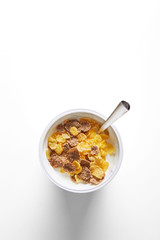 Corn flakes breakfast meal on a white background. Top view