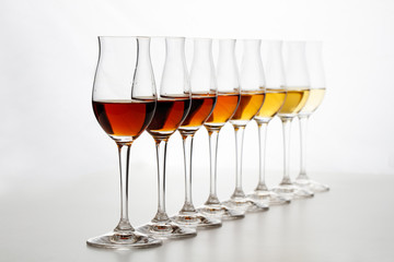 Row of cognac glasses with different stages of aging