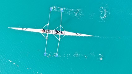 Aerial drone bird's eye view of sport canoe operated by young fit man in turquoise clear waters © aerial-drone