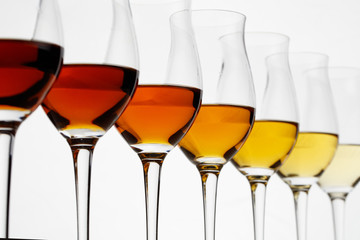 Row of cognac glasses with different stages of aging