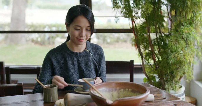 Woman enjoy the Hakka Lei Cha at tea house