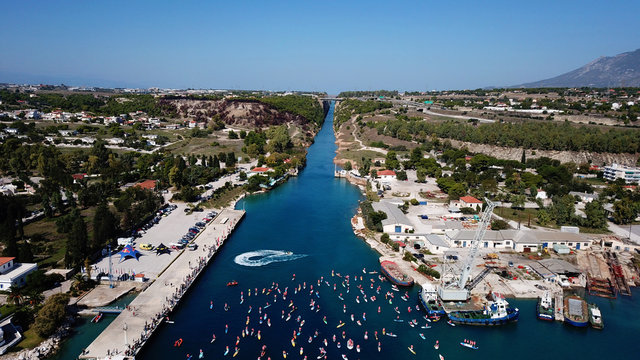 Aerial bird's eye view photo taken by drone of stand up paddle surfing or SUP competition in Corinth Canal of Isthmos or Isthmus, Peloponnese, Greece
