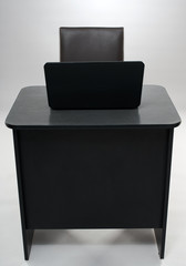 Desk and laptop on gray