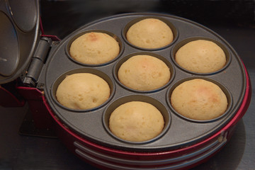 Electric oven for quick cooking of muffins. Electric oven with ready cupcakes.