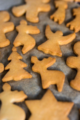 winter concept - close up of cookies or gingerbreads in hot oven