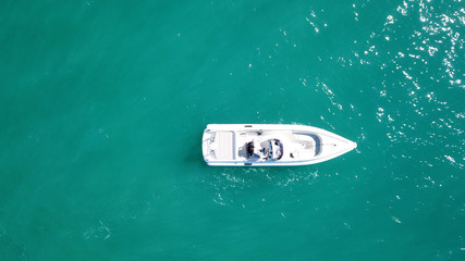 Aerial bird's eye top view photo taken by drone of boat docked in caribbean tropical beach with...