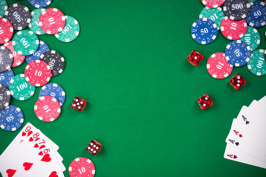 Casino games related items on green table, copy space - Powered by Adobe