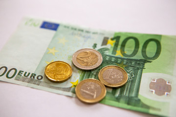 Euro coins on a paper bill
