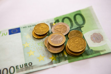 Euro coins on a paper bill