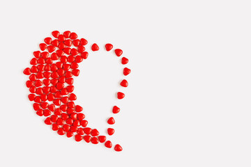 Valentines day background with red candy hearts, top view