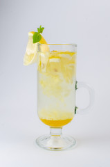 tea with honey, lemon, cinnamon and mint in a clear glass