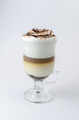 latte with cinnamon in a glass beaker on a white background