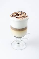 latte with cinnamon in a glass beaker on a white background