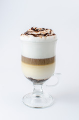 latte with cinnamon in a glass beaker on a white background