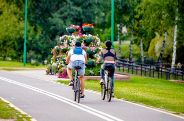 Cyclists ride on the bike path in the city Park 