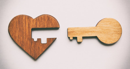 Wooden heart and key from this one isolated on the white background. valentines concept