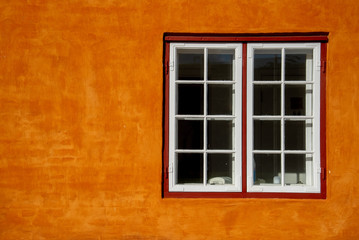 Fototapeta na wymiar Window on the orange wall