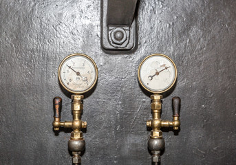 Old valves and gauges placed in a  machine control room