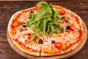 Pizza from seafood with mussels and shrimps and arugula