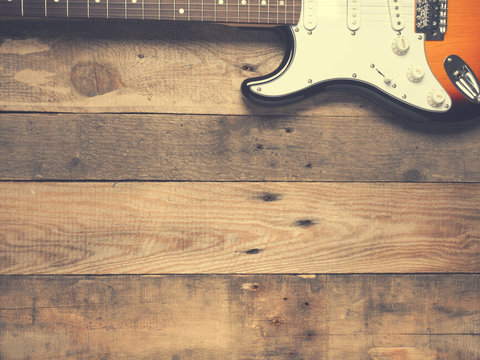 Old vintage guitar on rustic wood - Powered by Adobe