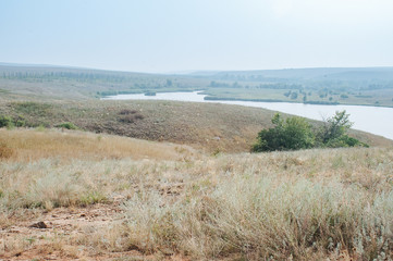 Freshwater reservoir in the Luhansk steppes in Ukraine. Summertime landscape panorama of region of Ukraine near to Russia