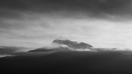 Fototapeta na wymiar Foggy cloudscape on a mountain range landscape and grey sky