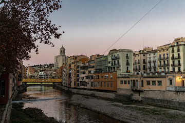 Girona river houses famous landmark at sunset