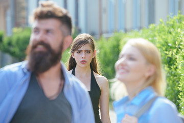 She is jealous. Unhappy girl feeling jealous. Bearded man cheating his girlfriend with another...