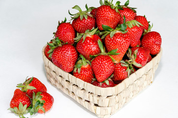 red strawberry in wicker bowl
