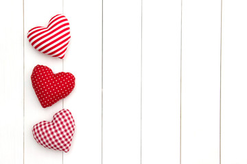 Pillow hearts shape on white wood planks with copy space. Happy Valentine's day card mockup. Minimal style. Flat lay.